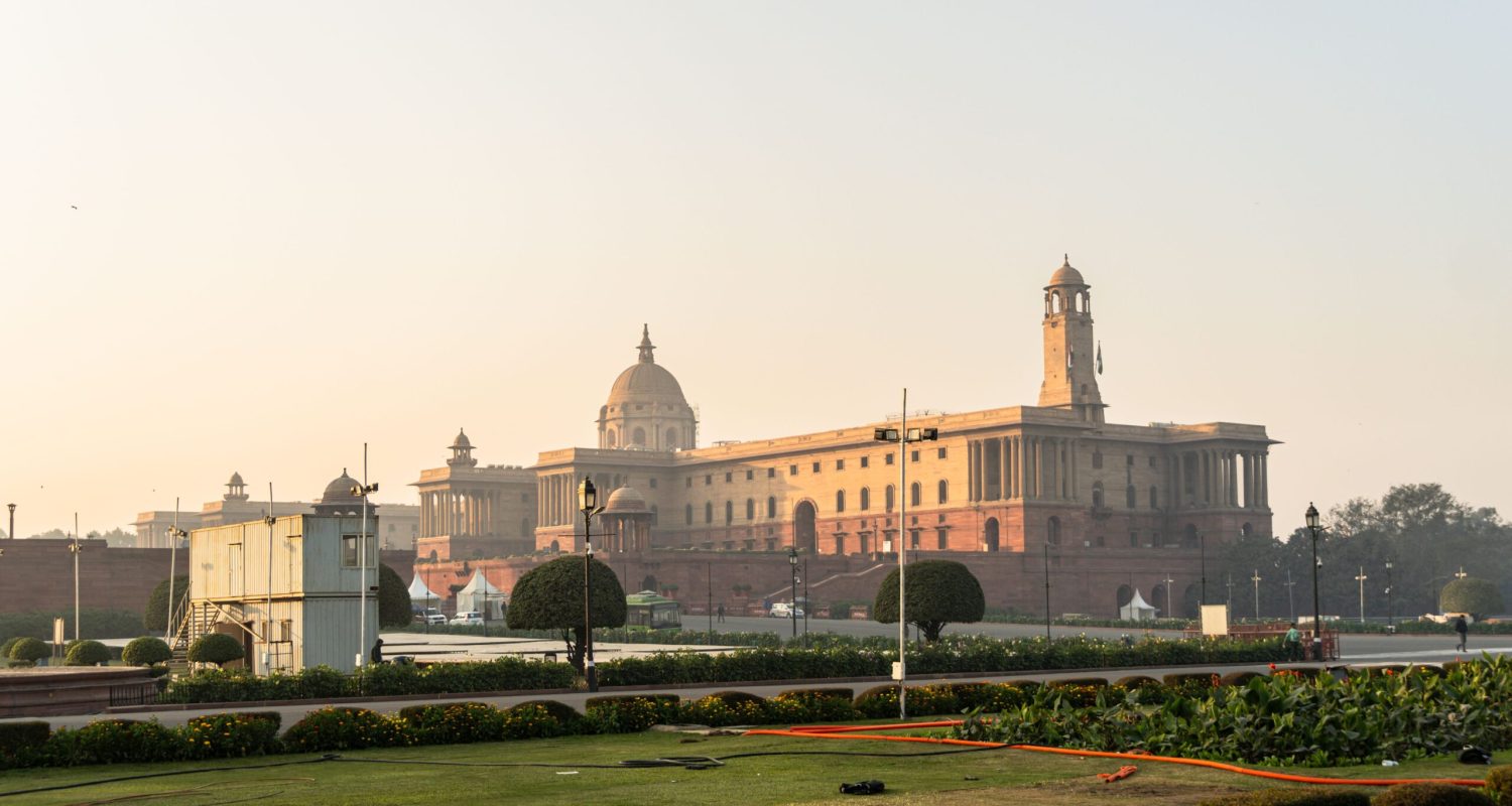 Stunning view of Rashtrapati Bhavan with a clear sky in New Delhi, India, during sunrise.